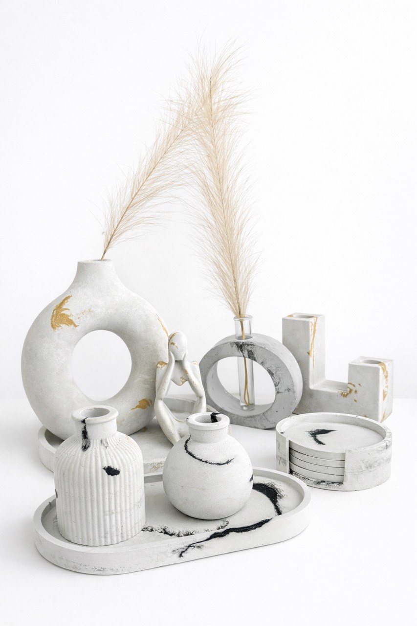 Decorative white vases and objects with dried grass on a tray against a white background.