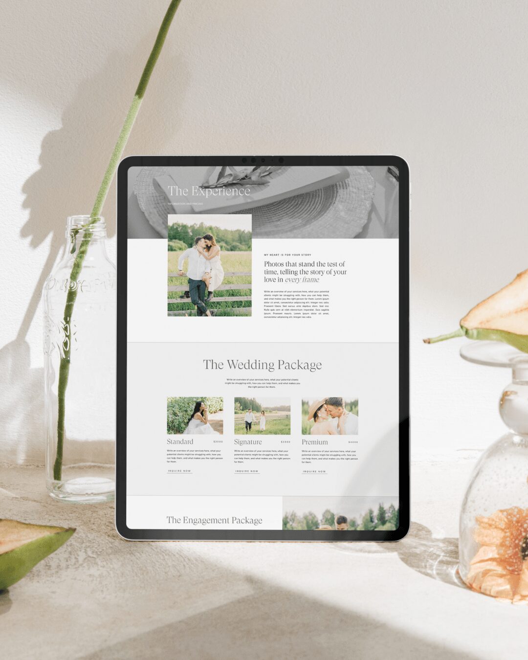 Tablet displaying a wedding package webpage, placed on a surface with decorative plants and objects around it.