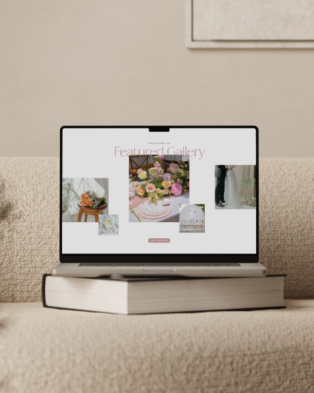 Laptop displaying a gallery of floral and decorative images, placed on a closed book on a beige carpeted surface.