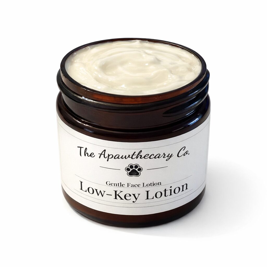 Open jar of face lotion with white cream inside, labeled 'Low-Key Lotion' by The Apothecary Co.