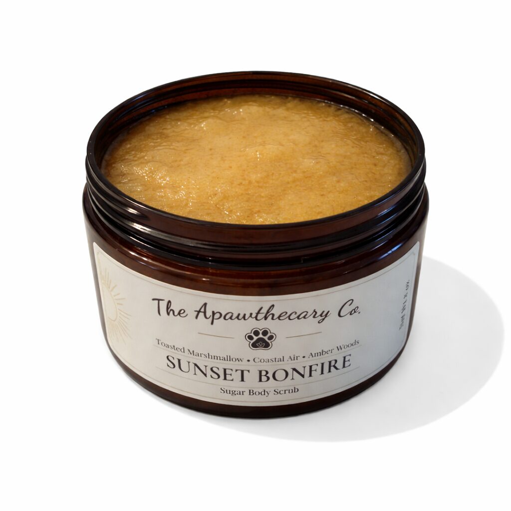 Brown container with a label, filled with a yellowish scrub or body product, on a white background.