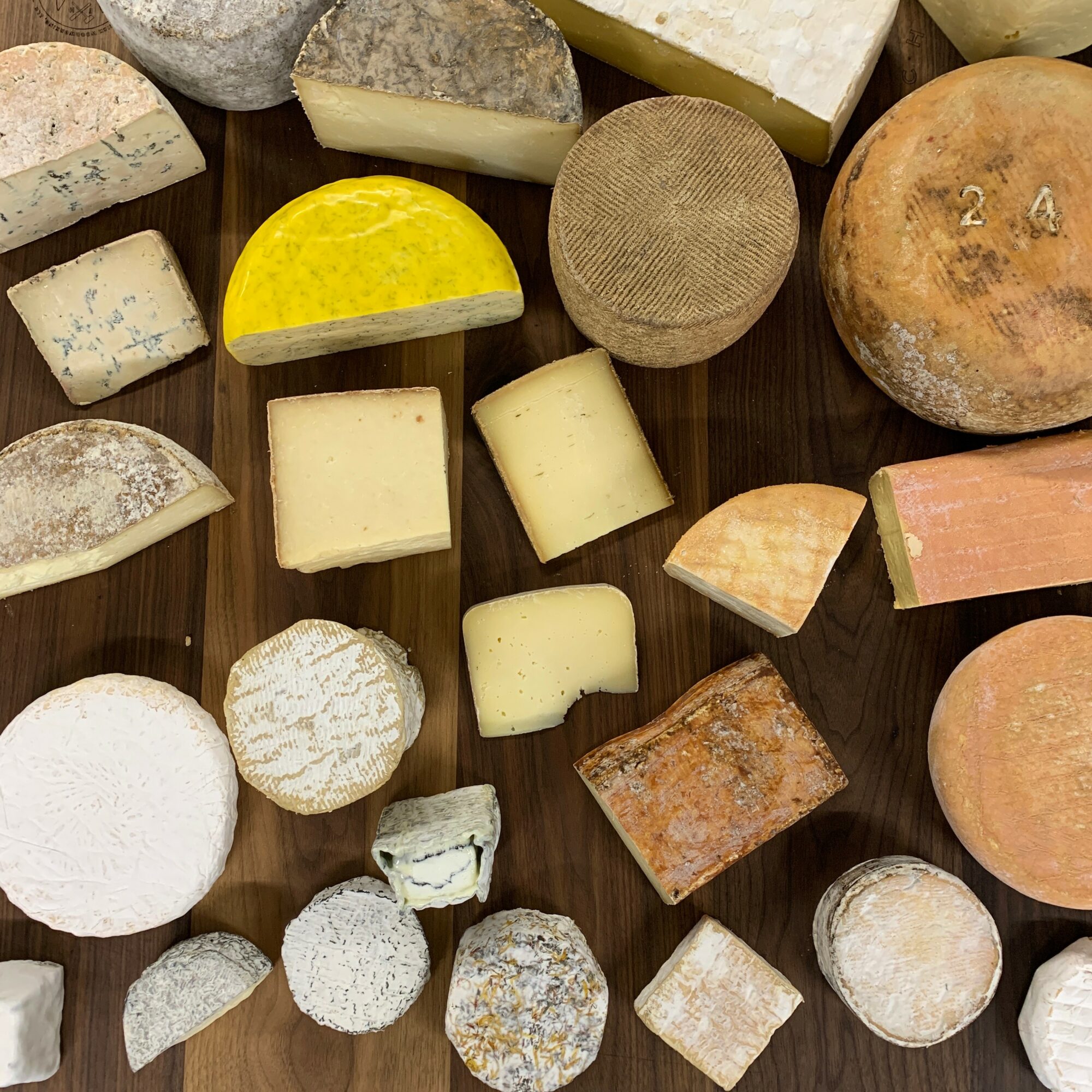 Various types of soap bars and stones arranged on a dark surface.