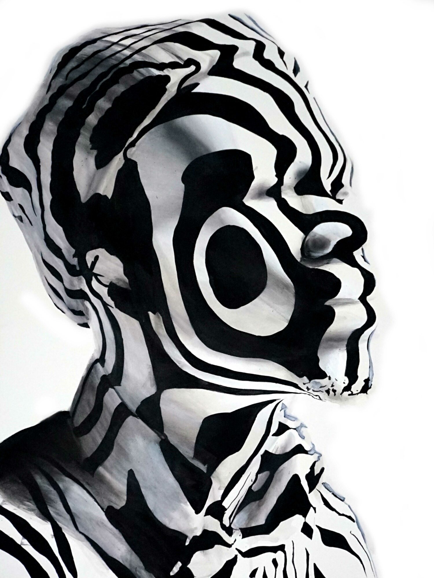 Profile of a person with black and white abstract patterns on face and clothing, facing right.