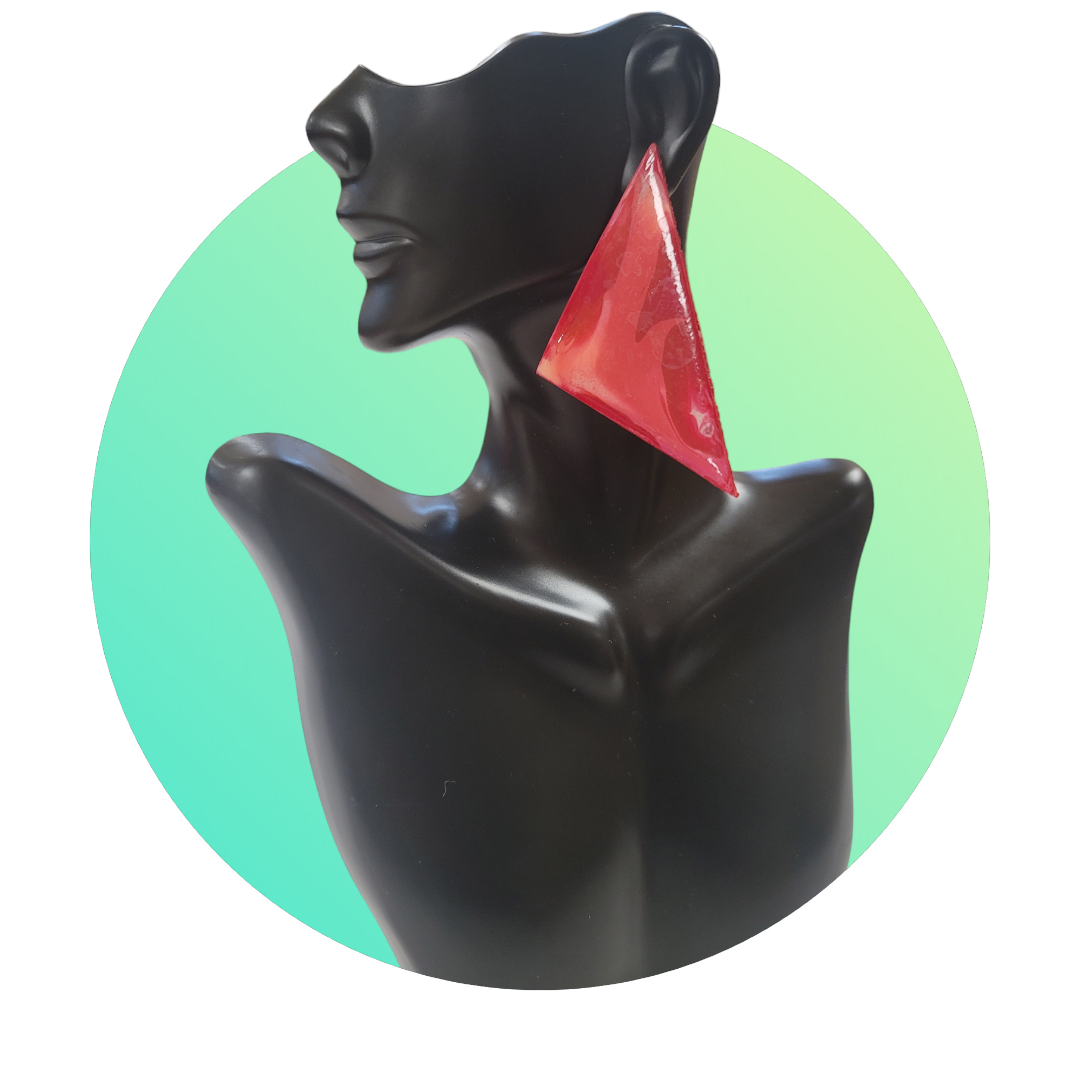Black mannequin bust with a red triangular earring against a green gradient background.