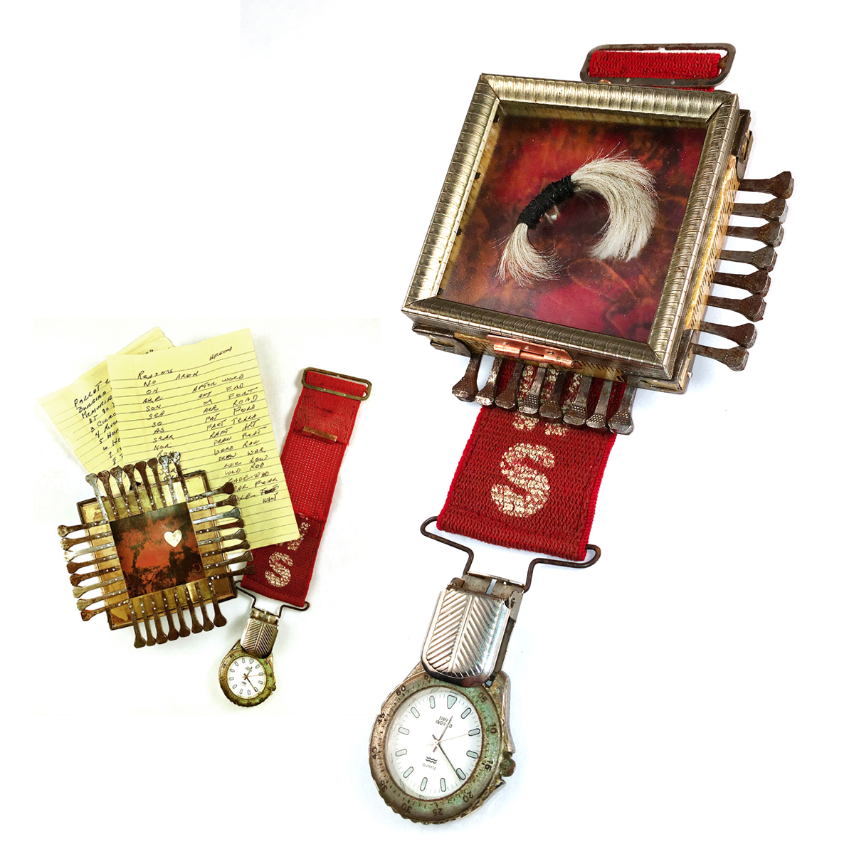 Two watches with attached frames and papers, one with a red strap and the other with a red and silver strap, on a white background.
