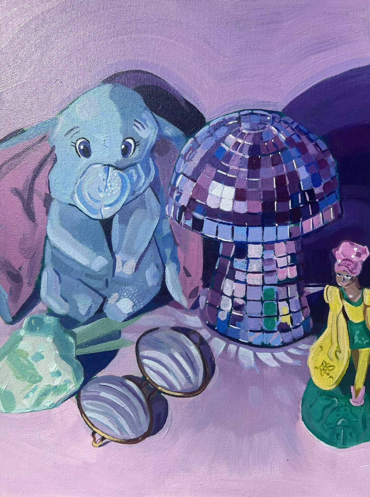 Elephant figurine with a pacifier, a disco ball, sunglasses, and a small figurine, all on a purple surface.