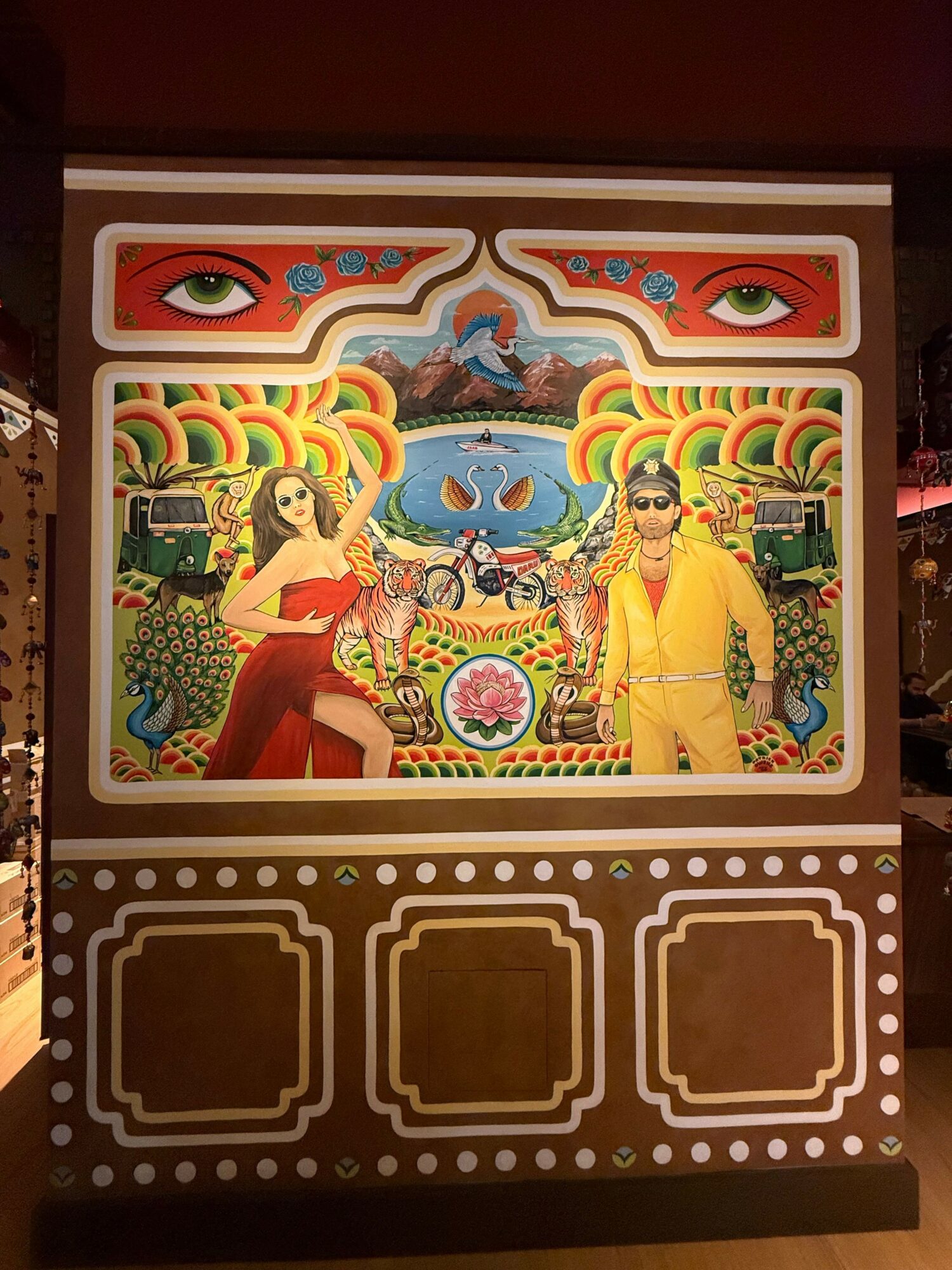 Colorful illustration of two women in traditional attire surrounded by decorative patterns and animals.