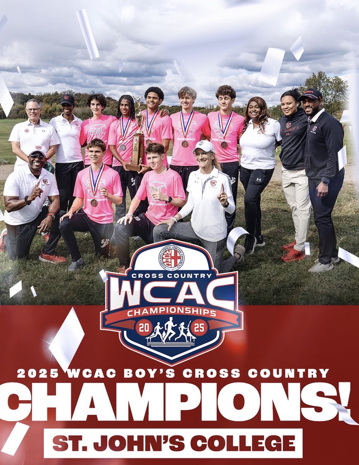 Group of young athletes and coaches outdoors, holding medals and a trophy, celebrating cross country championship victory, with a cloudy sky.