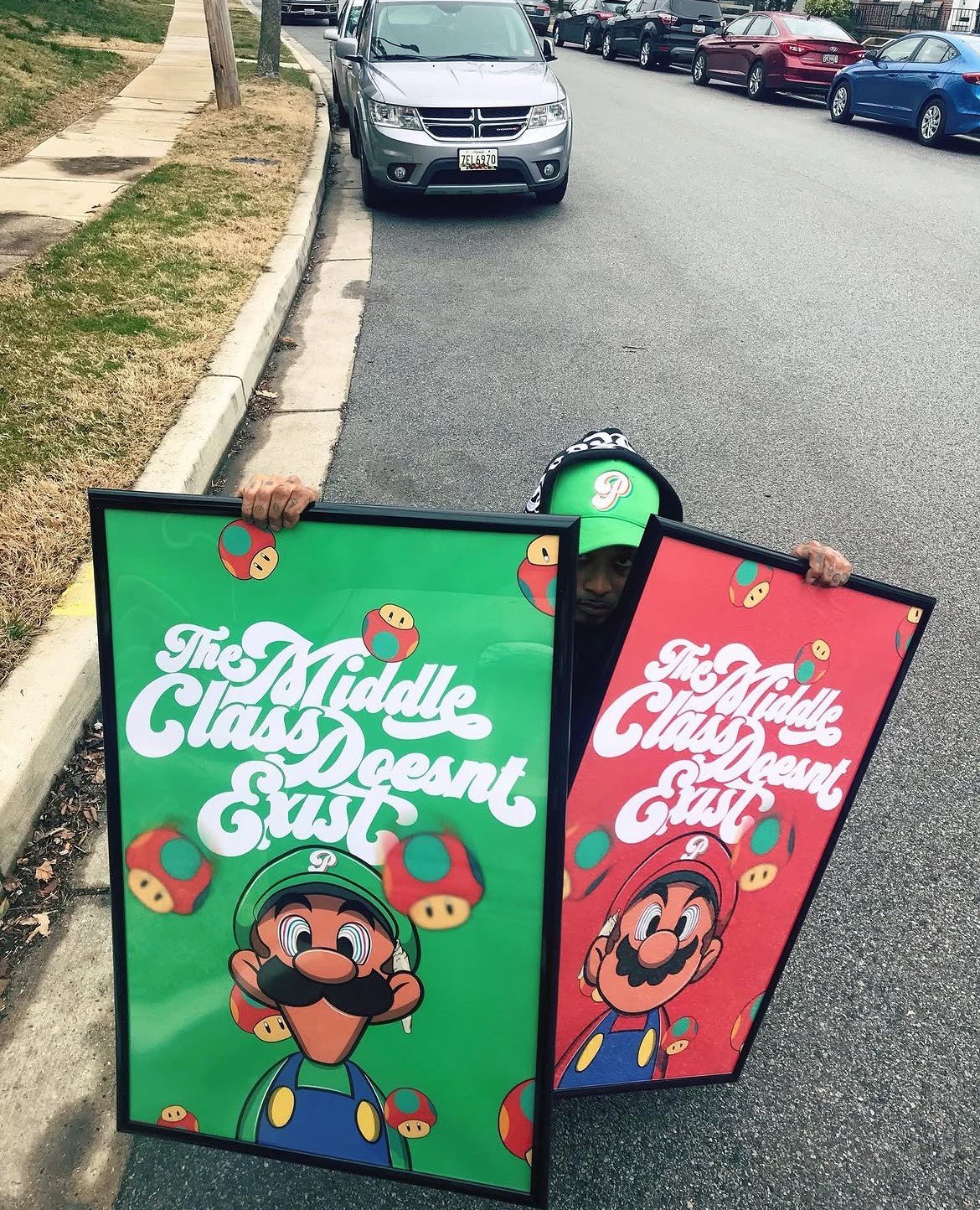 Two people hold signs with Mario and Luigi from Super Mario, with colorful backgrounds and text about middle school.