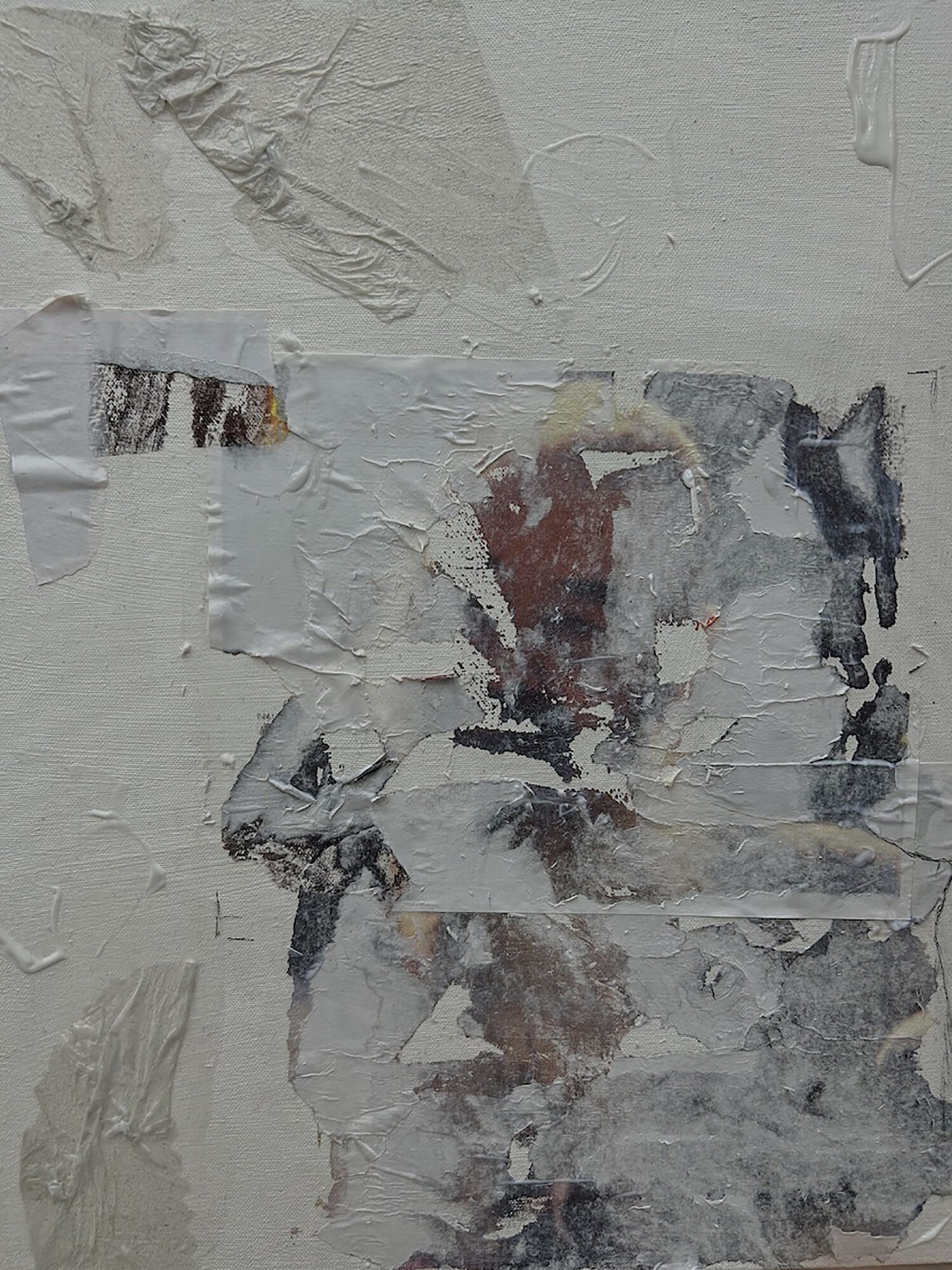 Abstract textured wall with peeling paint and layered materials, mostly in white, gray, and brown tones.