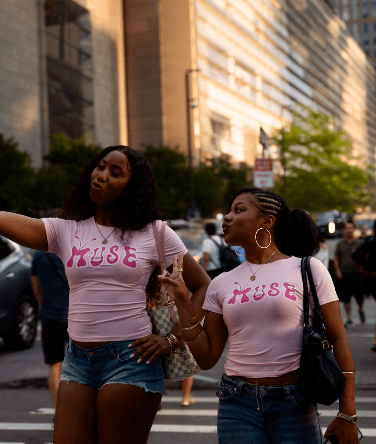 Two women wearing matching pink T-shirts with