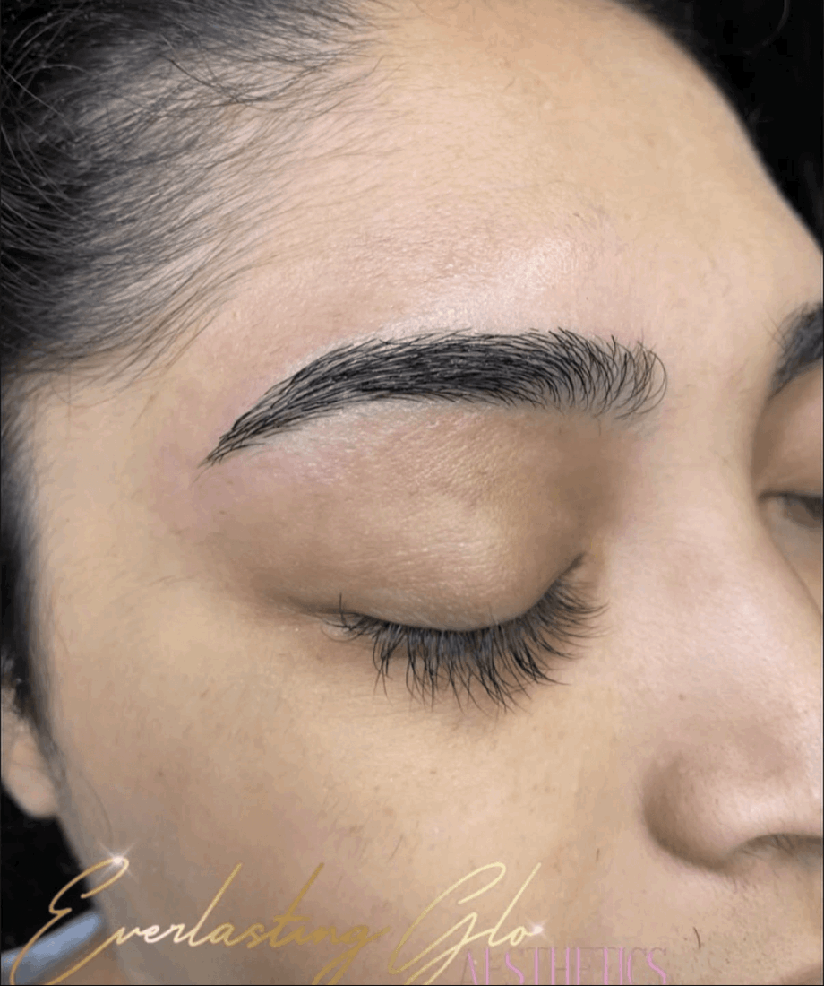 Close-up of a woman's face with closed eyes, showing eyebrows and skin texture.