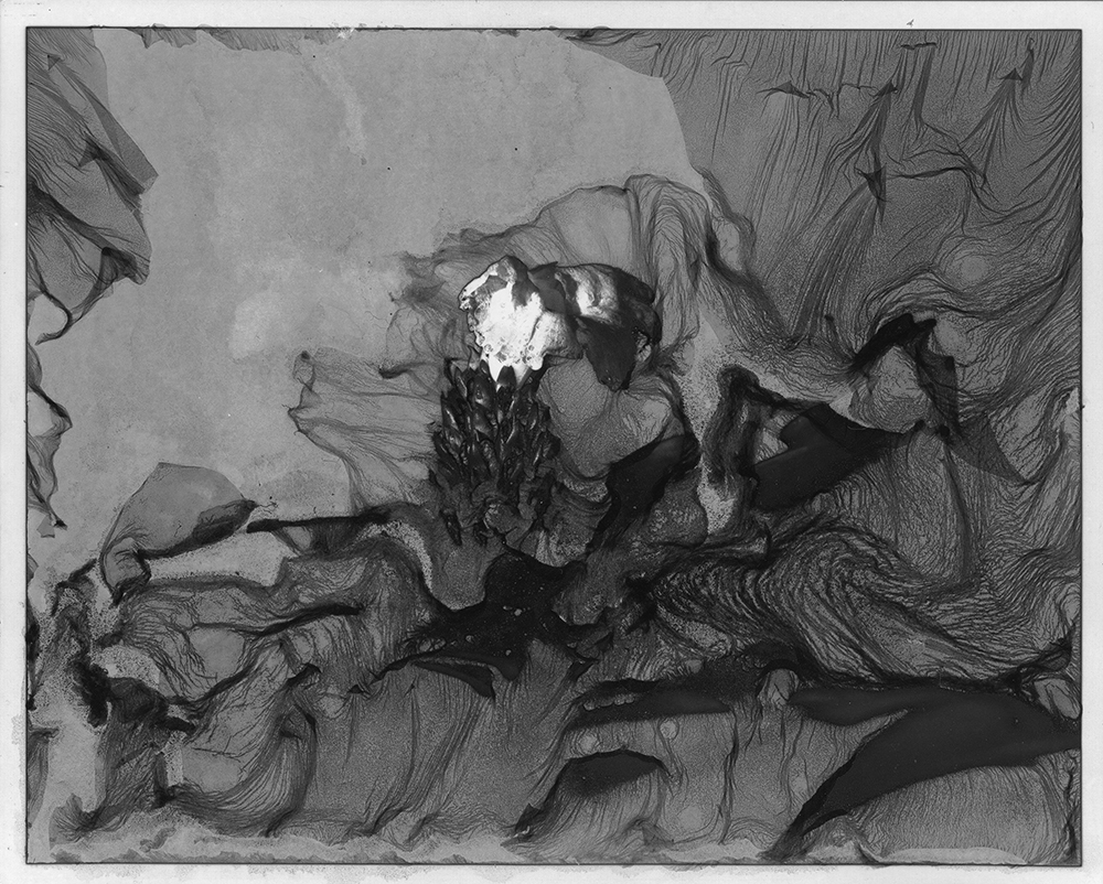 Abstract black and white drawing with a central figure surrounded by flowing lines and shapes.
