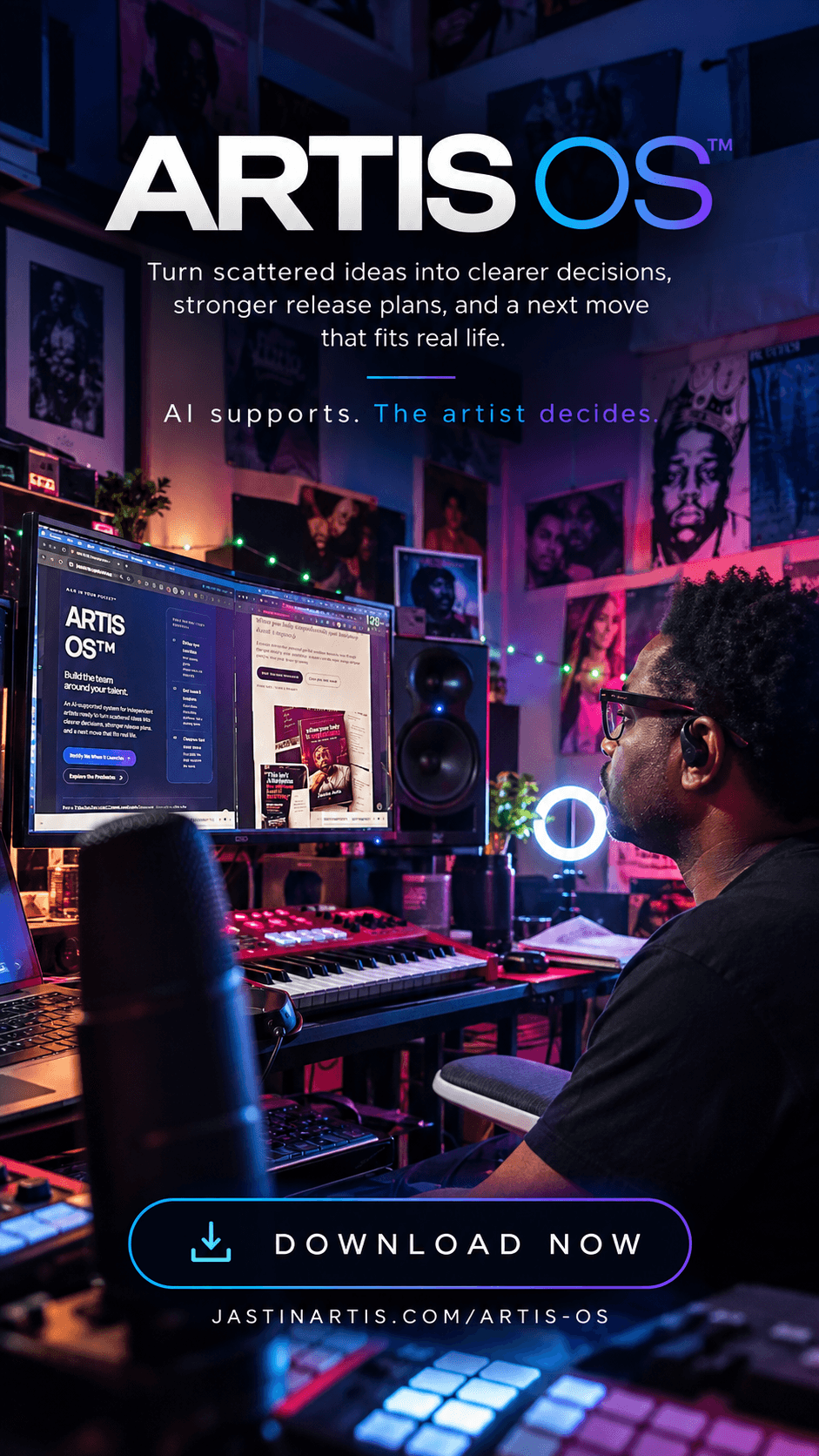Person with glasses in a music studio with computer, speakers, and colorful artwork on walls.