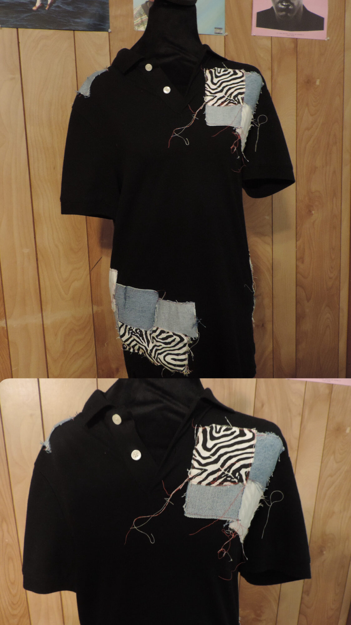Black dress with patterned fabric patches on chest and lower part, displayed on a mannequin against a wooden background.